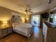 Serene bedroom showcasing a dresser, TV, and access to a balcony at 22375 Edgewater Dr # F219, Port Charlotte, FL 33980