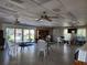 Large common room with tables, chairs, sliding doors, and a bookshelf for residents to enjoy at 22375 Edgewater Dr # F219, Port Charlotte, FL 33980
