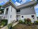 Inviting exterior view of a two-story condo with a cozy seating area and lush landscaping at 22375 Edgewater Dr # F219, Port Charlotte, FL 33980