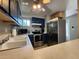 Bright kitchen with stainless steel appliances, including a microwave, stove, and refrigerator at 22375 Edgewater Dr # F219, Port Charlotte, FL 33980