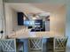 Updated kitchen with dark blue cabinets, stainless steel appliances, and a bright countertop at 22375 Edgewater Dr # F219, Port Charlotte, FL 33980