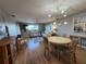 Bright living room with modern lighting fixture, dining area, and comfortable seating arrangements at 22375 Edgewater Dr # F219, Port Charlotte, FL 33980