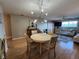 Inviting living room with open dining area, wood flooring, and comfortable sofa; great for gatherings at 22375 Edgewater Dr # F219, Port Charlotte, FL 33980