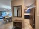 The dining area sits adjacent to a compact kitchen with blue cabinets and stainless appliances at 22375 Edgewater Dr # F219, Port Charlotte, FL 33980