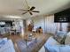 Cozy living room with wood flooring, ceiling fan, and comfortable white sofas with blue cushions at 22375 Edgewater Dr # F219, Port Charlotte, FL 33980