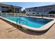 A sparkling community swimming pool with lounge chairs and tables offer a place to relax at 22375 Edgewater Dr # F219, Port Charlotte, FL 33980