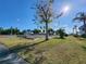 Outdoor shuffleboard court next to other community sports in a lush green setting and clear blue sky at 22375 Edgewater Dr # F219, Port Charlotte, FL 33980