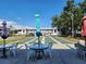 Picturesque shuffleboard courts with tables and chairs for relaxing and enjoying outdoor activities at 22375 Edgewater Dr # F219, Port Charlotte, FL 33980