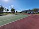Outdoor tennis court near condominium. The court is green and red with white boundary lines at 22375 Edgewater Dr # F219, Port Charlotte, FL 33980