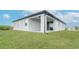 A covered back porch offers a shaded outdoor space accessible through sliding glass doors, surrounded by green grass at 234 Cougar Way, Rotonda West, FL 33947