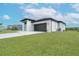 A single-story home boasts a well-kept lawn, complemented by a stylish gray roof and garage door at 234 Cougar Way, Rotonda West, FL 33947
