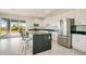 Modern kitchen featuring white cabinets, black countertops, stainless steel appliances and a sliding glass door at 234 Cougar Way, Rotonda West, FL 33947