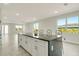 Modern kitchen features a large island with a dark countertop and seating at 234 Cougar Way, Rotonda West, FL 33947