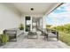 Covered patio with modern outdoor furniture and sliding glass doors at 234 Cougar Way, Rotonda West, FL 33947