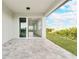 Covered patio featuring brick flooring and views of the landscaped backyard at 234 Cougar Way, Rotonda West, FL 33947