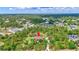 Aerial view of a property with mature trees and lush landscaping in a quiet neighborhood at 2700 Sheboygan Ave, North Port, FL 34286
