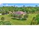 Expansive property featuring a large lawn, mature trees, and a screened-in pool at 2700 Sheboygan Ave, North Port, FL 34286