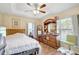 Inviting bedroom with wood floors, ceiling fan, and ample natural light from large windows at 2700 Sheboygan Ave, North Port, FL 34286