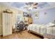 Well-lit bedroom offering wood floors, ceiling fan, and a comfortable space for relaxation and personalization at 2700 Sheboygan Ave, North Port, FL 34286