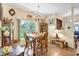 Charming dining area with wooden table and chairs, complemented by natural lighting and decor at 2700 Sheboygan Ave, North Port, FL 34286