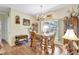 Dining area with unique chandelier, wooden table and chairs, and bright window views at 2700 Sheboygan Ave, North Port, FL 34286