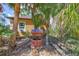 Exterior view of a well surrounded by palm trees and lush landscaping at 2700 Sheboygan Ave, North Port, FL 34286