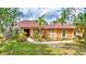 Charming single-story home featuring a well-maintained lawn and lush landscaping at 2700 Sheboygan Ave, North Port, FL 34286
