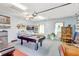 Spacious garage featuring recreational space with a pool table, mini fridge, and decorated with floral accents and a TV at 2700 Sheboygan Ave, North Port, FL 34286