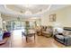 Spacious living room with sliding glass doors and refined chandelier at 2700 Sheboygan Ave, North Port, FL 34286