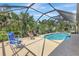 Inviting screened-in pool area featuring comfortable lounge chairs for relaxing and soaking up the sun at 2700 Sheboygan Ave, North Port, FL 34286