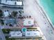 Aerial view of a beachfront condo with pool and courtyard, offering direct access to the pristine sandy beach at 2792 N Beach Rd # 301, Englewood, FL 34223