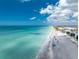 Beautiful beachside condos on a gorgeous, pristine beach with turquoise water on a bright, sunny day at 2792 N Beach Rd # 301, Englewood, FL 34223