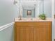 Well-maintained bathroom with a modern vanity, wood cabinetry, and neutral decor at 2792 N Beach Rd # 301, Englewood, FL 34223