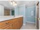 Bathroom with a wood vanity, a large mirror, and a tiled shower at 2792 N Beach Rd # 301, Englewood, FL 34223