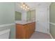 Bright bathroom with updated vanity, oak cabinets and tile flooring at 2792 N Beach Rd # 301, Englewood, FL 34223