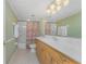 Bathroom featuring extended vanity with oak cabinetry and neutral tile floors at 2792 N Beach Rd # 301, Englewood, FL 34223