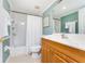 Bathroom featuring a tiled shower and tub with an oak vanity at 2792 N Beach Rd # 301, Englewood, FL 34223