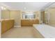 Luxurious bathroom with a soaking tub, double vanity, and a glass-enclosed shower for a spa-like experience at 2792 N Beach Rd # 301, Englewood, FL 34223