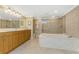 Elegant bathroom featuring a soaking tub, a separate shower, and a double vanity with ample counter space at 2792 N Beach Rd # 301, Englewood, FL 34223