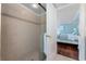 Bathroom with a tile shower and an open doorway to the bedroom at 2792 N Beach Rd # 301, Englewood, FL 34223