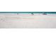 Expansive white sand beach with clear turquoise water, perfect for relaxing and enjoying the ocean views at 2792 N Beach Rd # 301, Englewood, FL 34223