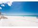 Beautiful sandy beach with clear blue water and a boardwalk leading to the condos at 2792 N Beach Rd # 301, Englewood, FL 34223