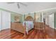 Spacious bedroom features hardwood floors, decorative four-poster bed and neutral decor at 2792 N Beach Rd # 301, Englewood, FL 34223
