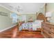 Bedroom with hardwood floors and a window with shutters at 2792 N Beach Rd # 301, Englewood, FL 34223