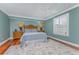 Bedroom with hardwood floors, a decorative rug, and shuttered window at 2792 N Beach Rd # 301, Englewood, FL 34223