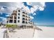 Elegant building offers stunning views and convenient beach access, framed by lush greenery at 2792 N Beach Rd # 301, Englewood, FL 34223