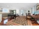 Open dining area flowing into the kitchen with hardwood floors and stylish furniture at 2792 N Beach Rd # 301, Englewood, FL 34223
