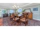 Elegant dining room featuring a stylish chandelier, hardwood floors, and plenty of space for entertaining guests at 2792 N Beach Rd # 301, Englewood, FL 34223