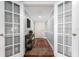 Bright entryway with french doors, console table, and decorative rug, creating a welcoming first impression at 2792 N Beach Rd # 301, Englewood, FL 34223