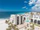 Beachfront condo with balconies and palm trees, complemented by community pool and a vibrant coastal neighborhood at 2792 N Beach Rd # 301, Englewood, FL 34223
